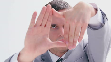 serious brunette man making a hand gesture