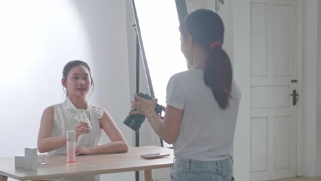 Behind The Scenes On Photo Shoot: Beautiful Asian Model Poses For A Photographer, She Takes Photos With Professional Camera