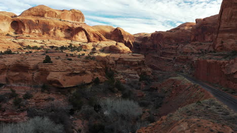 Aerial-panorama-of-the-Grand-Canyon-and-its-empty-road-surrounded-by-its-arid-mountains---drone-shot-dolly-in