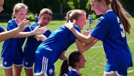 youth girls soccer team shows support and helps teammate