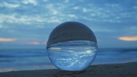 magic sunset view on the beach in a crystal ball.