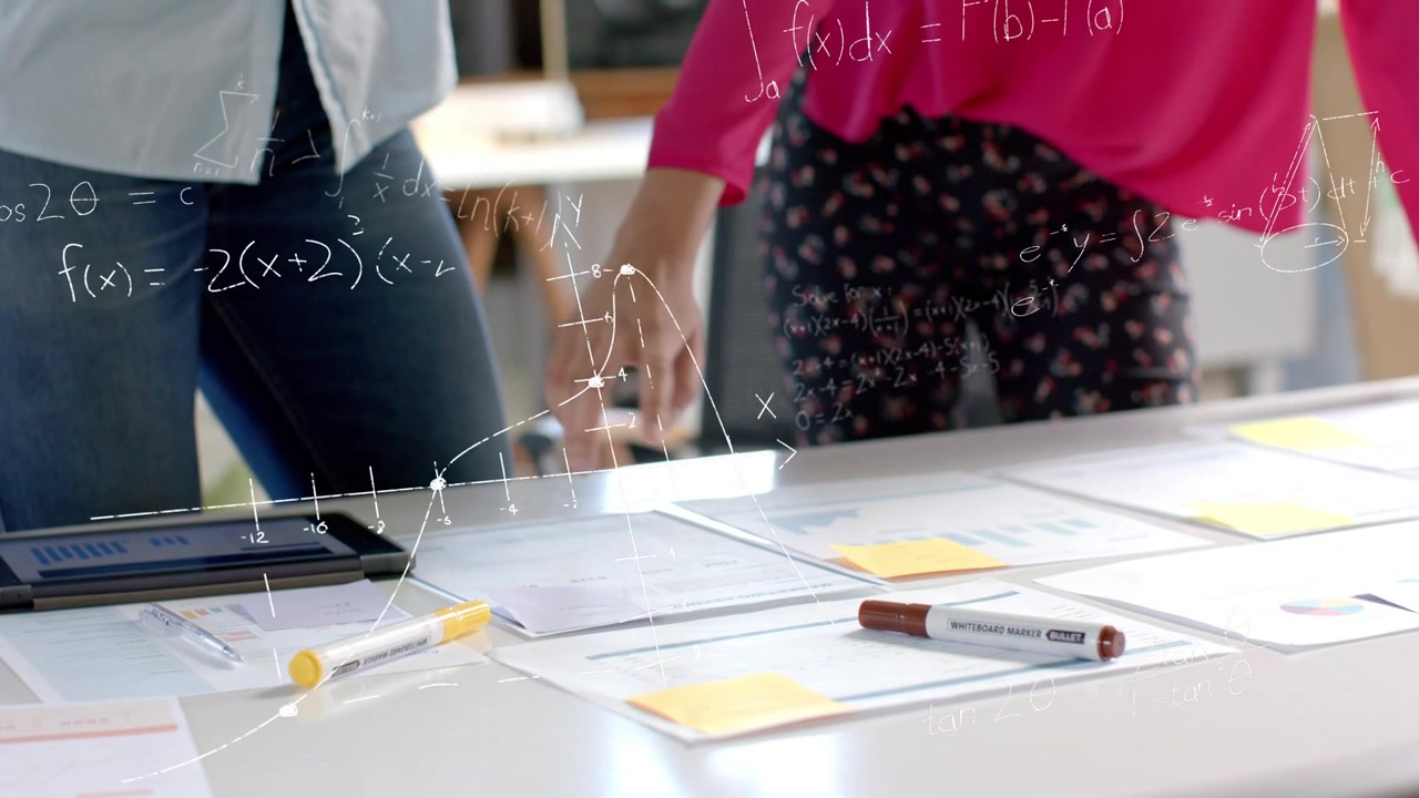 Vertical video: Team touching papers, reaching tablet and animating graphs over docs for business