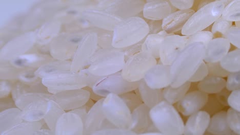 grains of raw rice rotate close-up