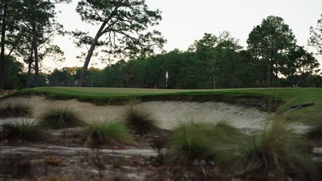 sand bunker in front of a golf green