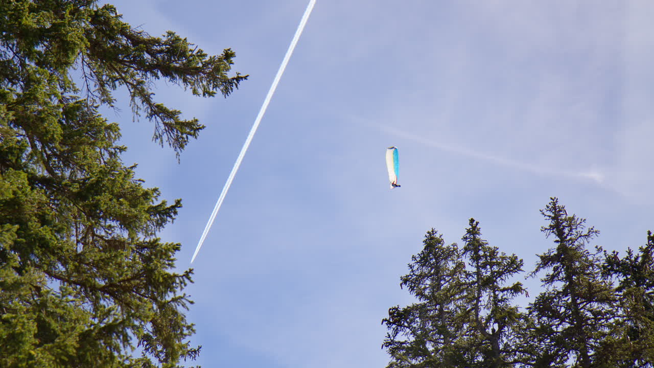 Paragliding Flight Near Bavarian Alps In Germany. Low Angle, Slow Motion Shot