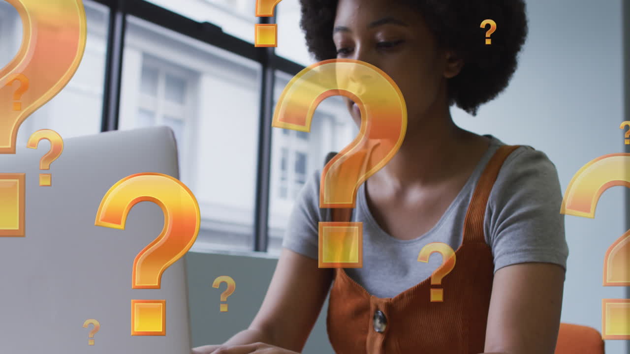 Animation of question marks over african american businesswoman using laptop