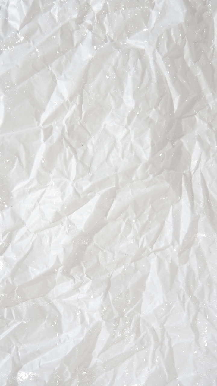 Abstract Torn Crumpled Paper Revealing Black Background