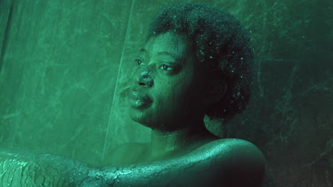 thoughtful african american woman standing in shower