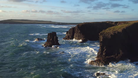 stunning cinematic reversing aerial shot of a rugged cornish coastline