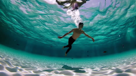 underwater adventures: man swimming in clear tropical water