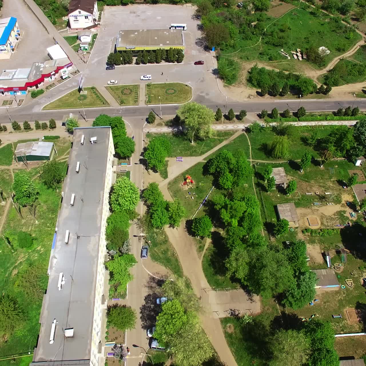 Green territory in the town near rural countryside. Beautiful daytime footage from aerial perspective