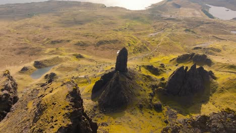 aerial drone footage of the dramatic mountain landscapes on the isle of skye, scotland. sweeping panoramic views of majestic peaks, green valleys, and wild nature. old man of storr