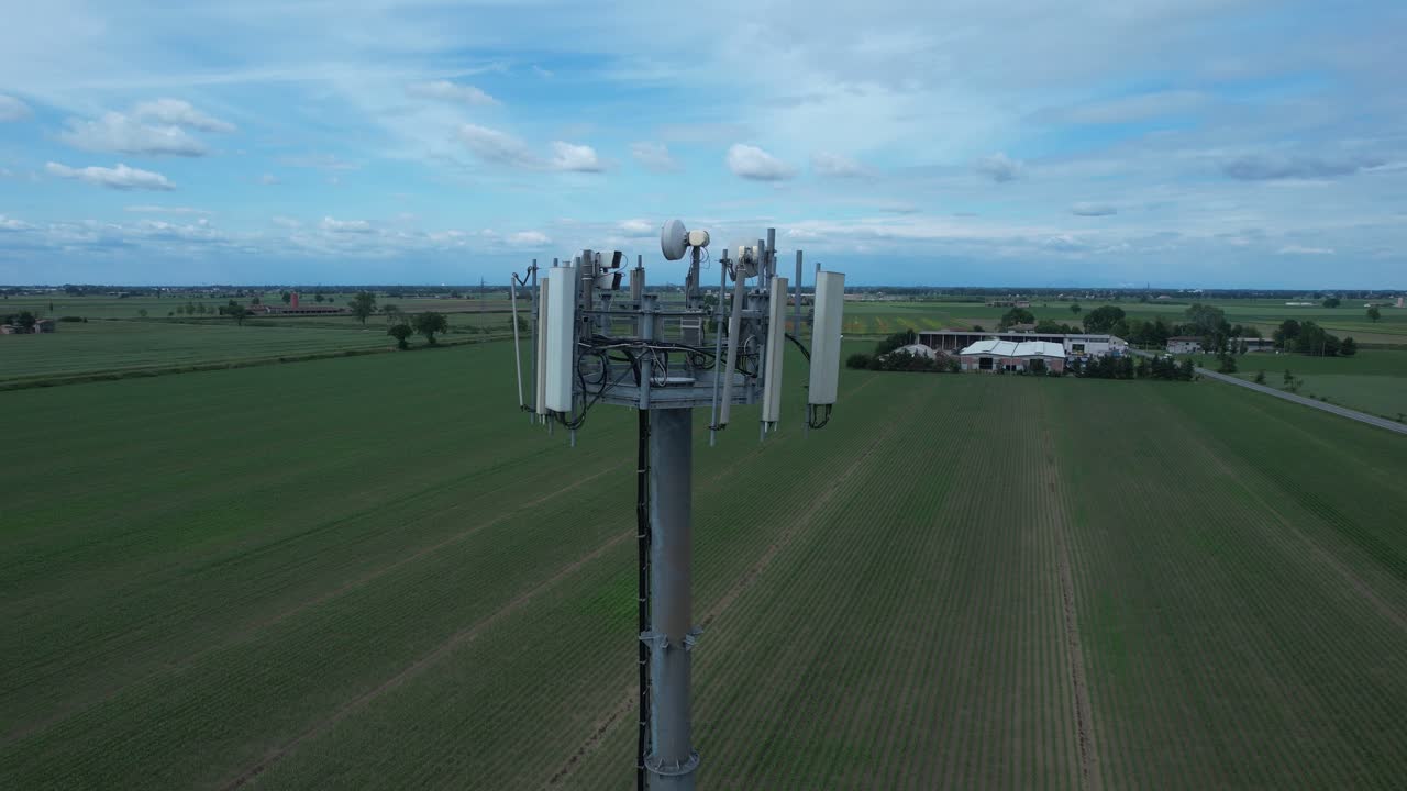 Torre della stazione base cellulare 5G che mostra antenne a pannello multisettore, unità radio remote, staffe di montaggio e cablaggio, illustrando la moderna infrastruttura di rete mobile per la connettività wireless ad alta velocità.