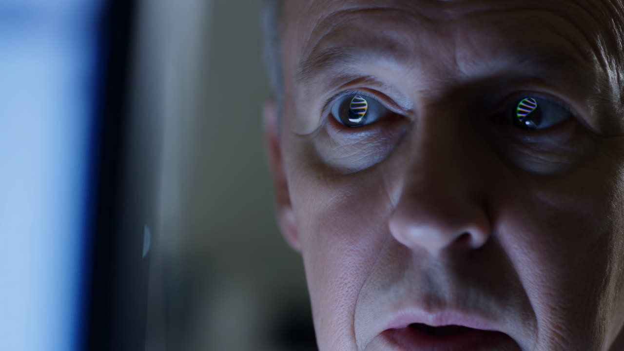 Close Up Man Face At Monitor, Latenight Cybersecurity Analyst Notices Data Breach Reflected In Eyes, Blue