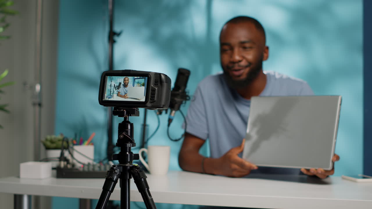 Close up of modern camera recording vlogger with laptop