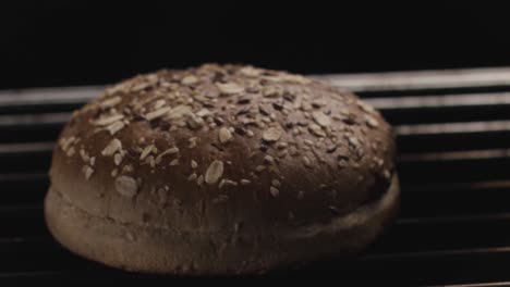 grilling a seed-topped bun