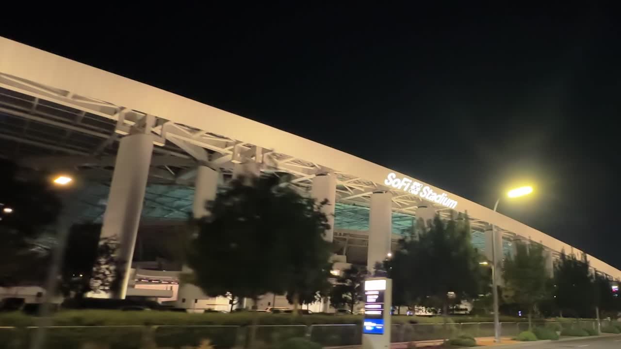 SoFi Stadium exterior at night, sports and entertainment venue in Inglewood
