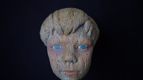 sculpture of young wooden boy face with a blue eyes, pinocchio the real boy