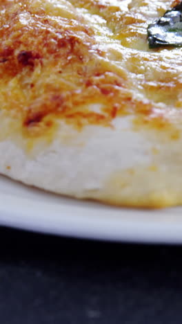 baked pizza served on plate