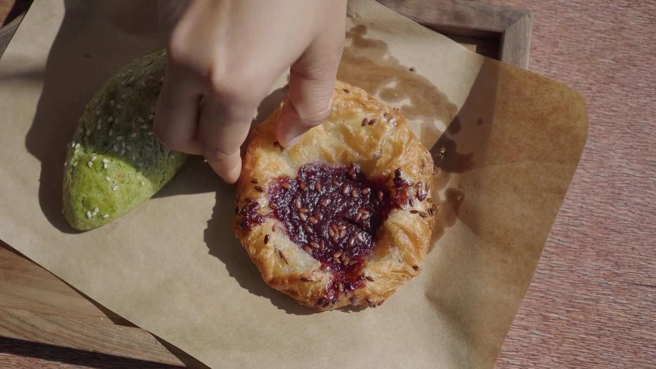 Delicious Berry Jam Danish Pastry and Green Bread on Table