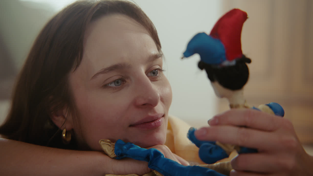 A girl playing with dolls in her room