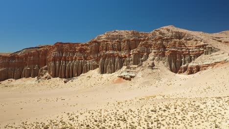 erosion of sandstone in the mojave desert results in natural monuments of spire rock in the sandy landscape