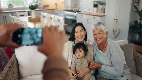phone screen, hands and picture of family