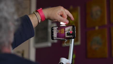 person configuring a video stabilizer with a mobile phone