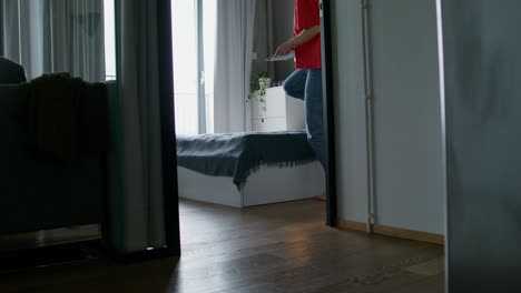 woman playing video game/using laptop in her bedroom