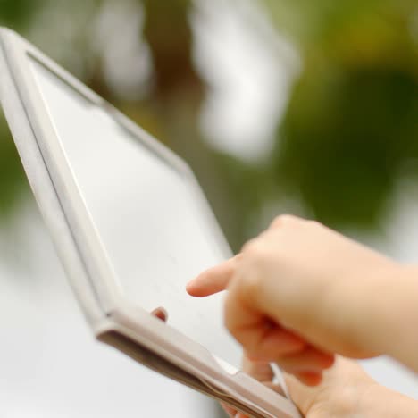 Close-Up-On-Woman-Hands-While-Using-Tablet