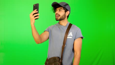 indian tourist taking selife on road with green background - green screen
