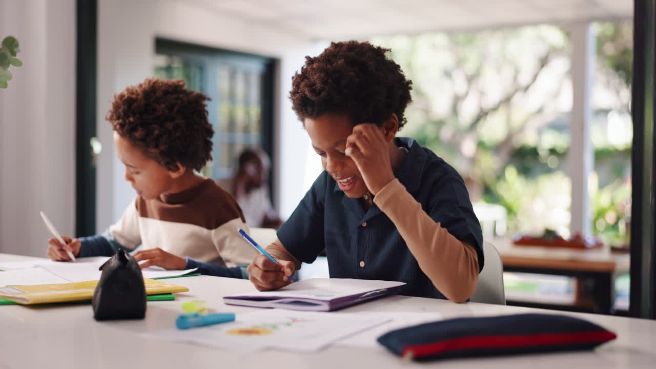 Two young boys doing homework at home