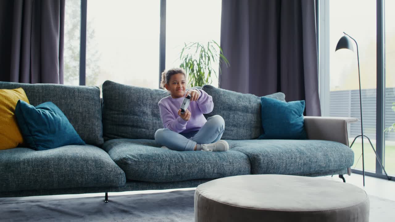 Girl playing video games on couch