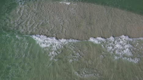 crashing waves of panama city beach resort in florida. aerial drone shot