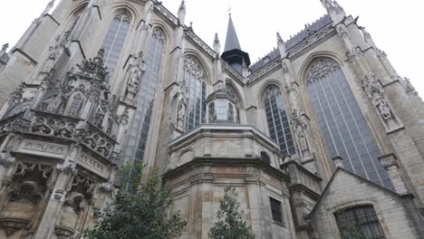 a gothic church facade with tall stained glass windows and intricate carvings