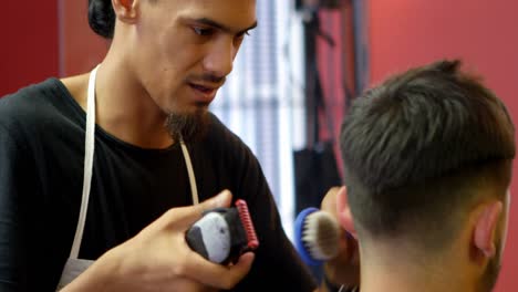 Man-getting-his-hair-cut-by-hairdresser-4k