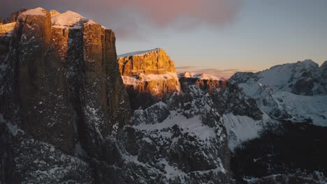 drones rise over the gold snowcapped dolomites