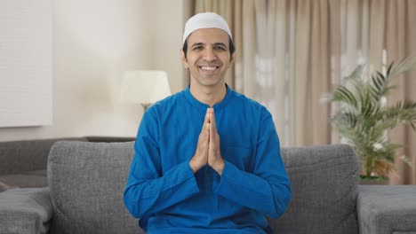 happy muslim man doing namaste