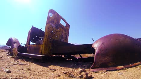 Dolly-shot-beside-an-abandoned-pickup-truck-in-the-desert-sun