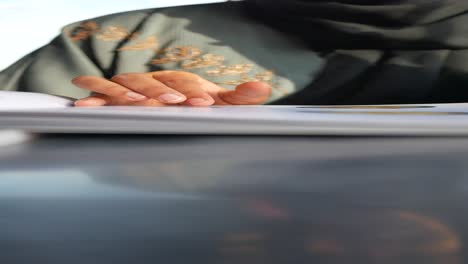 woman reading a book in an abaya