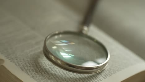 Magnifying-glass-on-large-opened-book