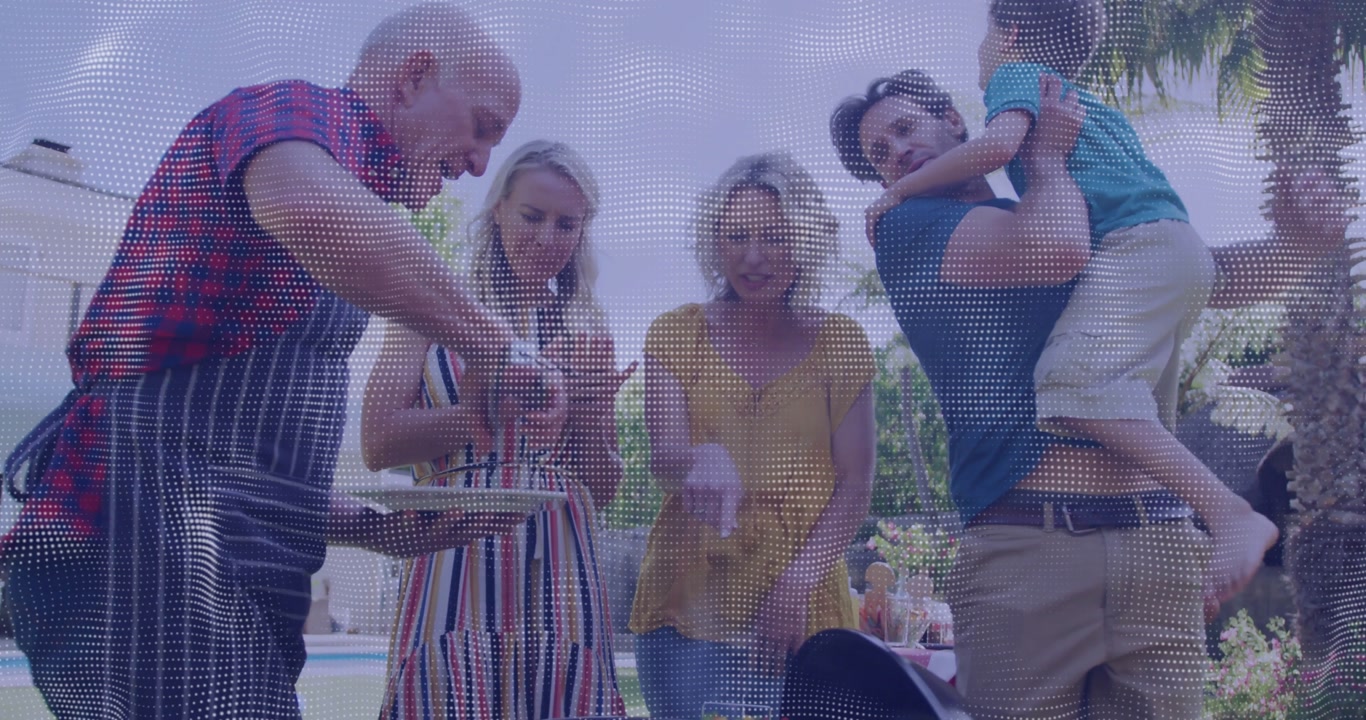 Elderly man using tongs at poolside grill, women seasoning skewers while family preparing dinner