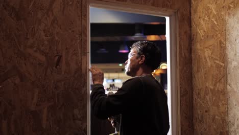 man using a grinder to repair a door