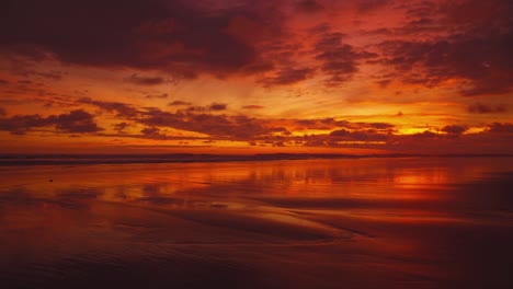 beautiful sunset on a wide and remote sandy pacific beach at manuel antonio national park, costa rica