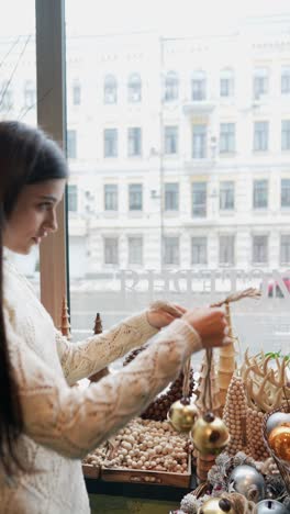 woman looking at christmas decorations