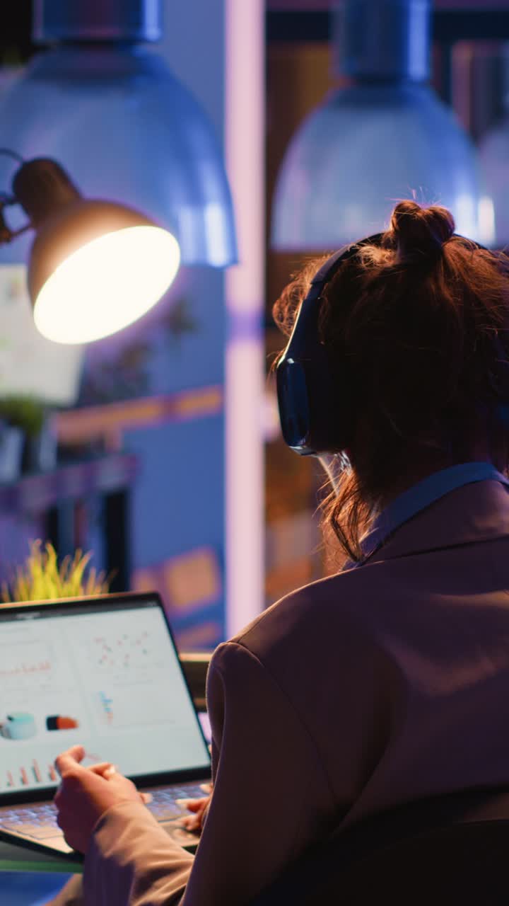 Vertical video: Focused employee analyzing financial graphs