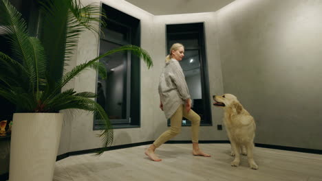 woman dancing with her dog in the living room