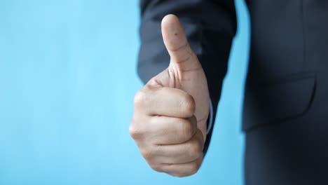 thumbs up gesture by business man