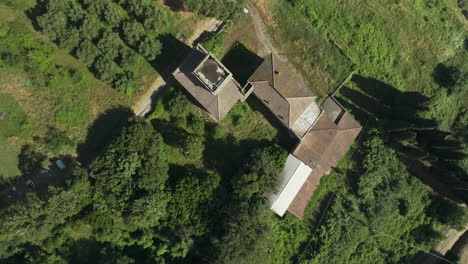 old italian villa surrounded by lush greenery and fields, aerial view