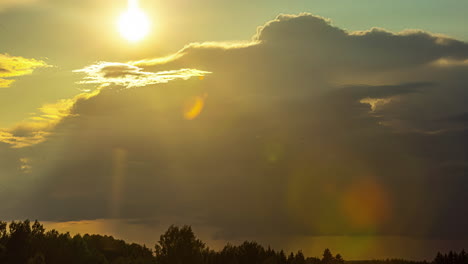 sunset time lapse cloudscape above the silhouette of the forest